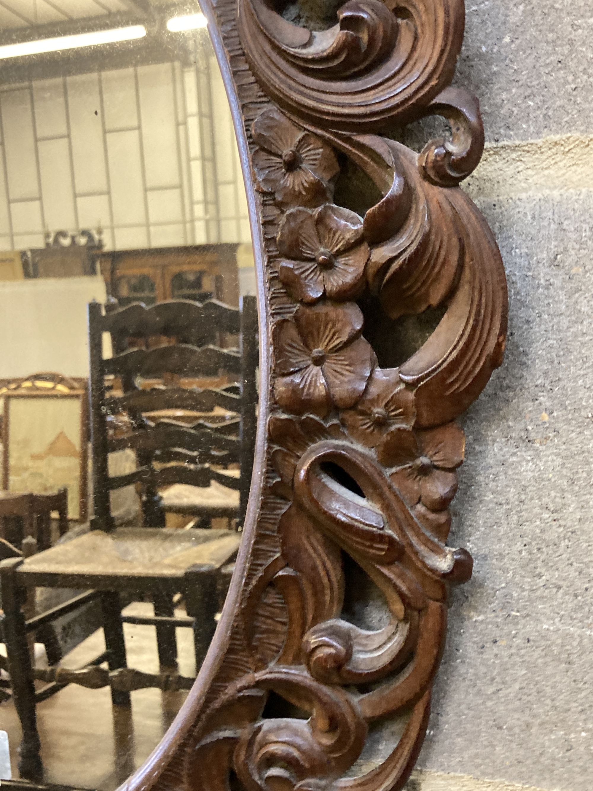 A Carolean style carved walnut oval mirror, width 48cm, height 68cm